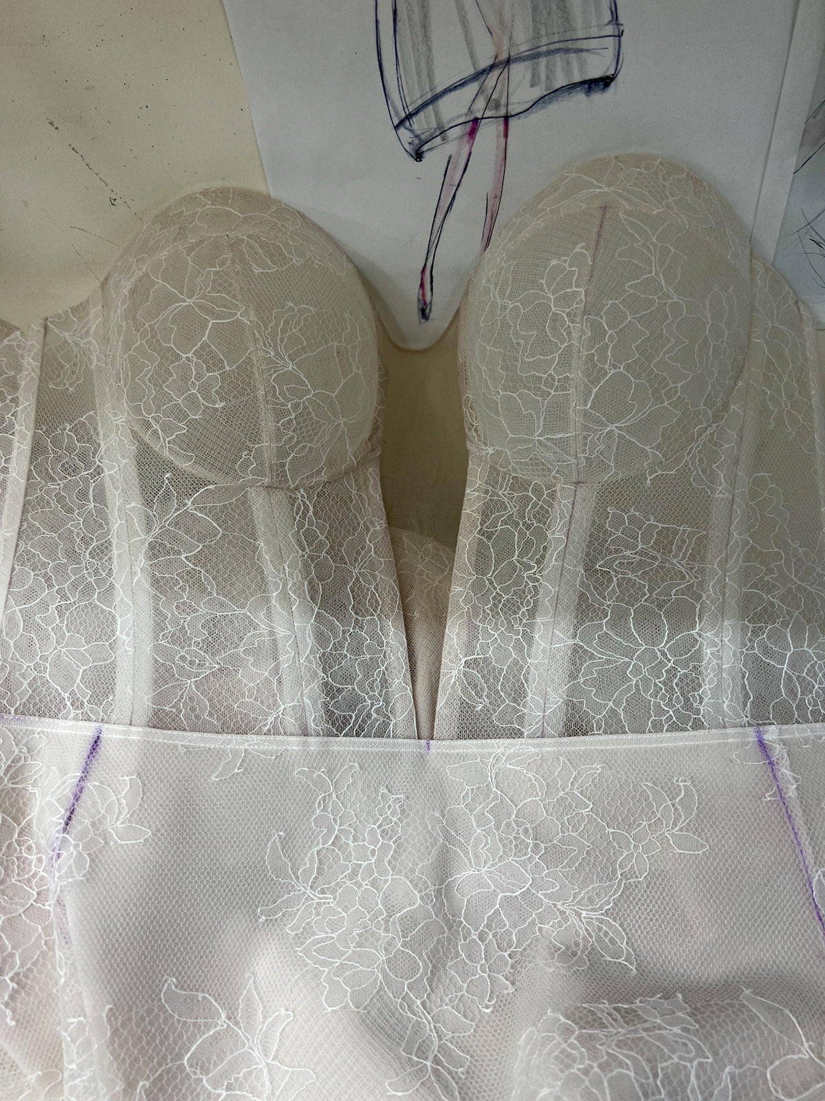 Ivory lace corset under construction with shaping marks visible