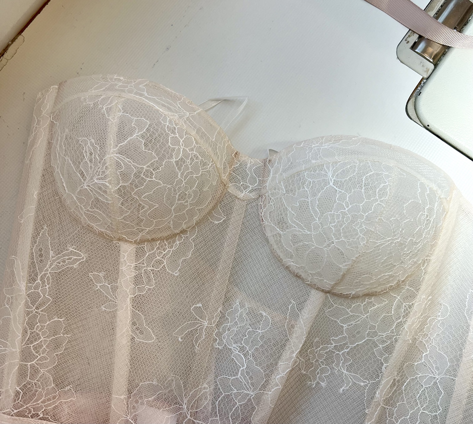 Close view of shaped ivory lace corset cups