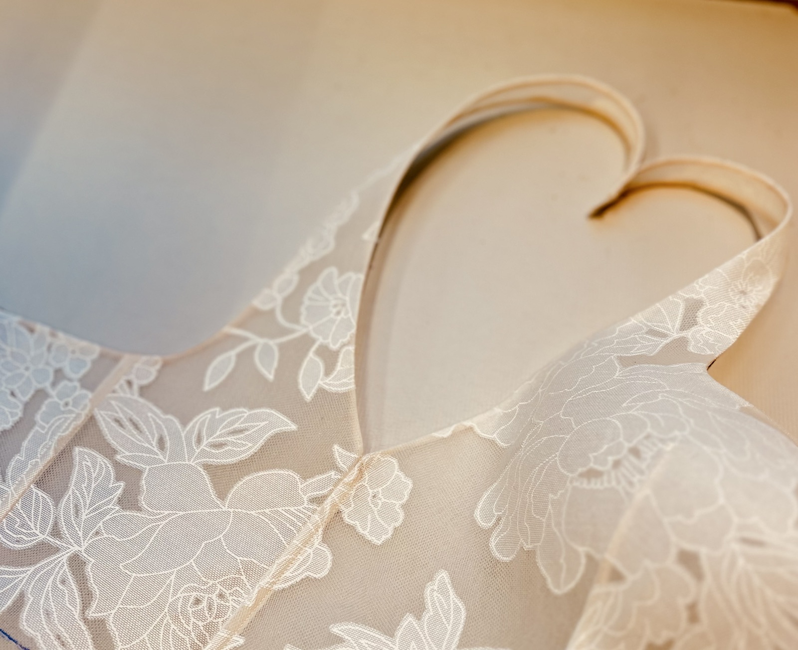 Ivory floral lace corset detail on a dress form