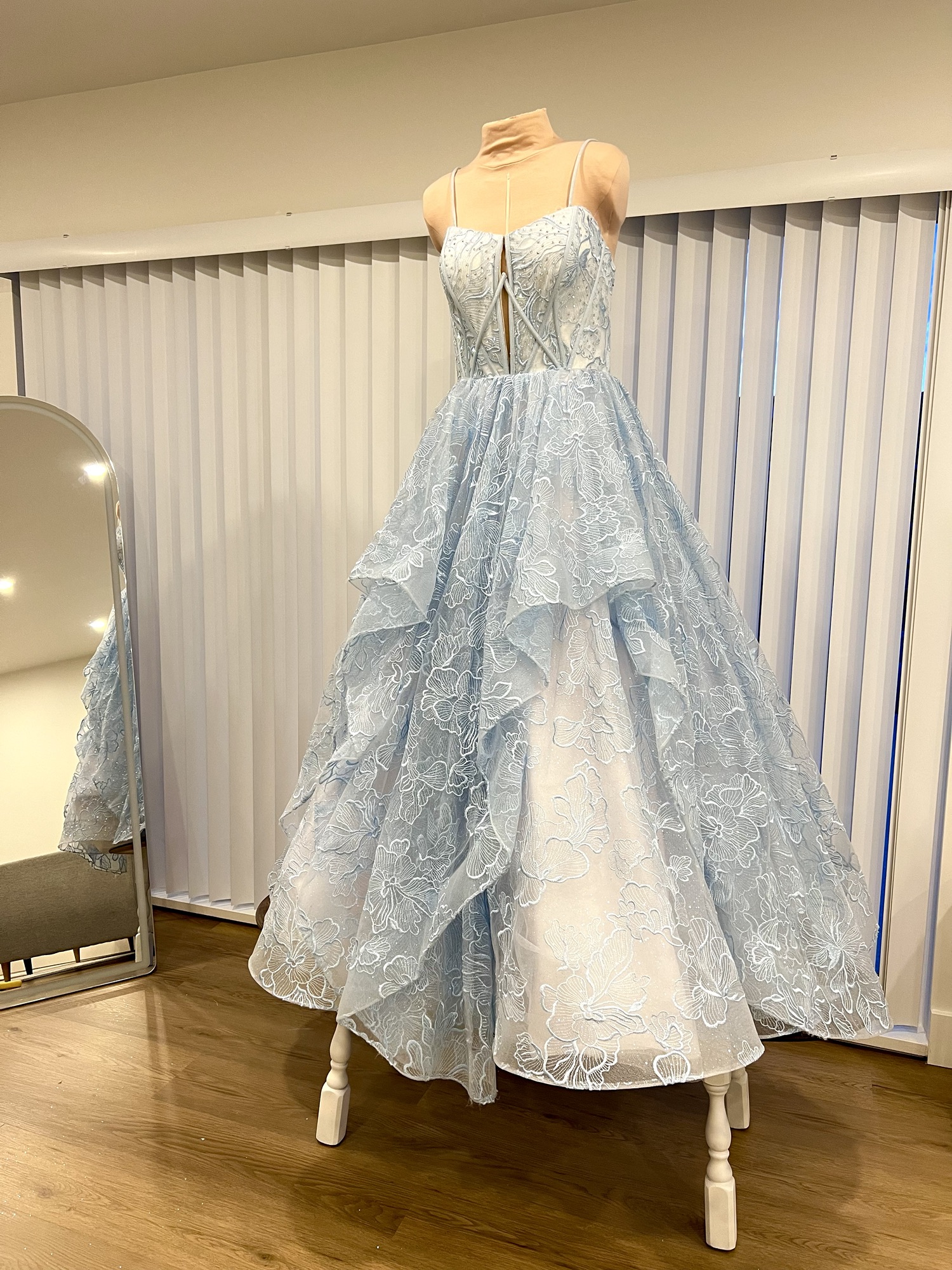 Powder blue couture gown with a structured bodice and layered skirt